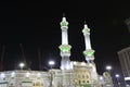 Pedestrians heading to the Haram Mosque in Mecca and Mecca Royal Clock Tower Hotel Royalty Free Stock Photo