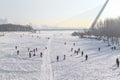 Harbin , Heilongjiang / China January 01 2015 : People walk on frozen river Songhua River in morning Royalty Free Stock Photo