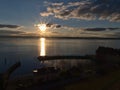 Harbor basin and pier in silhouette of town Meersburg, Germany on the shore of Lake Constance with bright evening sun.