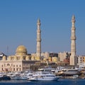 Harbor with boats and mosque at Hurghada on Red Sea in Egypt