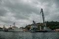 Harbor cargo cranes on evening sky background