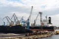 Harbor crane loading coal onto a freight ship in the industrial port of Ploce Royalty Free Stock Photo