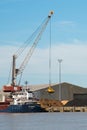 Harbor crane loading a ship with wood. Bordeaux port