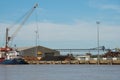 Harbor crane loading a ship with wood. Bordeaux port