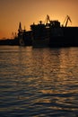 Harbor and Cranes against red sunset background Royalty Free Stock Photo