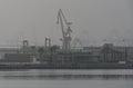 Harbor with mist and cranes Royalty Free Stock Photo