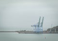 harbor cranes and ships waiting to load