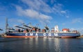 Harbor cranes unloading shipping containers from a CMA CGM vessel in the Port of Rotterdam, The Netherlands, September 8, 2013