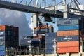 Harbor cranes unloading shipping containers from a vessel in the Port of Rotterdam, The Netherlands, September 8, 2013 Royalty Free Stock Photo