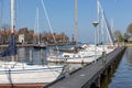 Harbor Dutch city Medemblik with yachts moored to wooden jetty