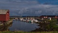 Harbor of fishing village Andenes in the north of AndÃÂ¸ya, Norway with docking boats, breakwaters and typical red houses.