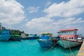 Harbor full of small fishermen`s and cargo boats located at Villingili island