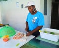 Local cook prepares traditional Bahamian conch salad in Caribbean restaurant in Harbor Island, Bahamas