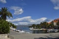 Harbor in the little village Splitska on Brac Island in Croatia, with some small boats and a palm to the left,view out over the s