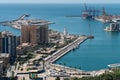 Harbor of Malaga view with La Farola lighthouse and container cranes, Spain Royalty Free Stock Photo