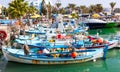 Harbor near Ayia Napa. Fishing boats, palms and tourists. Royalty Free Stock Photo