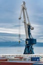 Harbor portal crane and many containers for shipping sea storage at terminal in sea port on coast of Pacific Ocean