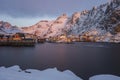 Harbor, rorbuer and snowy mountains at sunrise in Ãâ¦, Lofoten, N