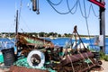 Harbor with sailing boats and a winch with fishing equipments in the foreground Royalty Free Stock Photo