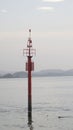 Harbor sign post tower beacon stands guard, or as a sea mark for harbor anchor area