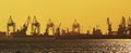 Harbor silhouette at sunset with cranes Royalty Free Stock Photo