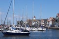 Harbor of small Dutch fishing town Urk with fishing and sailing boats and lighthouse Royalty Free Stock Photo