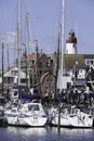 Small fishing town Urk west harbour with fishing and sailing boats and lighthouse