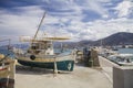 Old fishing boat on the shore. A ship pulled ashore. Harbor in the village of Hersonissos on the island of Crete, Greece. Royalty Free Stock Photo