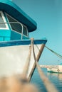 Harbored medium size fishing boat with ropes on a dock Royalty Free Stock Photo