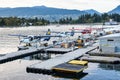 Harbour Air seaplanes/float planes/ pontoon planes docked in Coal Harbour, Vancouver, with Chevron Fueling Station in background