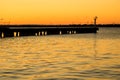 Harbour Beacon And Breakwater At Sunrise With Windmills In Background