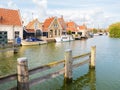 Harbour with boats and quayside with houses in old town of Makkum, Friesland, Netherlands