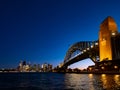 Harbour Bridge and Sydney city skyline at night against bright dark blue sky Royalty Free Stock Photo