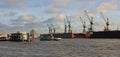 Harbour cranes in Hamburg. Boat on the Elbe. Royalty Free Stock Photo