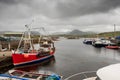 Harbour Derryherbert, fishing boats. Grey cloudy sky. Royalty Free Stock Photo