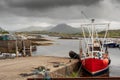 Harbour Derryherbert, fishing boats. Grey cloudy sky. Royalty Free Stock Photo