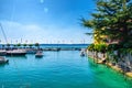 Harbour of Garda lake with blue azure turquoise water, wooden pier dock and yacht