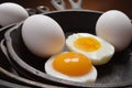 Hard boiled egg with fresh yoke in one half, all in cast iron skillets