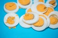Hard boiled eggs cut up on a blue cutting board Royalty Free Stock Photo