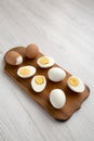 Hard Boiled Eggs on a rustic wooden board, side view. Space for text Royalty Free Stock Photo