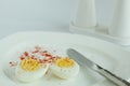 Hard boiled eggs sliced halves in white plate Royalty Free Stock Photo