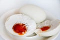 Hard boiled salted duck egg on white plate.