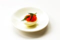 Hard-boiled sliced chicken egg half with red caviar and dill on white plate background Royalty Free Stock Photo