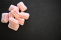 Close up food photography of sugar candy sweets in pink and white stripes on dark slate background and overhead view Royalty Free Stock Photo