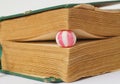 hard candy bewtween pages of an old book Royalty Free Stock Photo