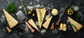 Hard cheese with olives and cheese knife on black stone background. Parmesan. Top view. Royalty Free Stock Photo