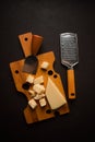 Hard cheese, parmesan, on a cutting board, cheese knife, grater, top view, no people, Royalty Free Stock Photo