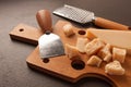 Hard cheese, parmesan, on a cutting board, cheese knife, grater, top view, no people, Royalty Free Stock Photo