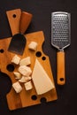 Hard cheese, parmesan, on a cutting board, cheese knife, grater, top view, no people, Royalty Free Stock Photo