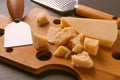 Hard cheese, parmesan, on a cutting board, cheese knife, grater, top view, no people, Royalty Free Stock Photo